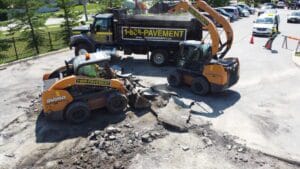 Asphalt being removed with skid steer